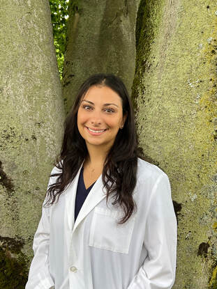 Doctor Efstratia Rigopolous smiling and wearing a lab coat